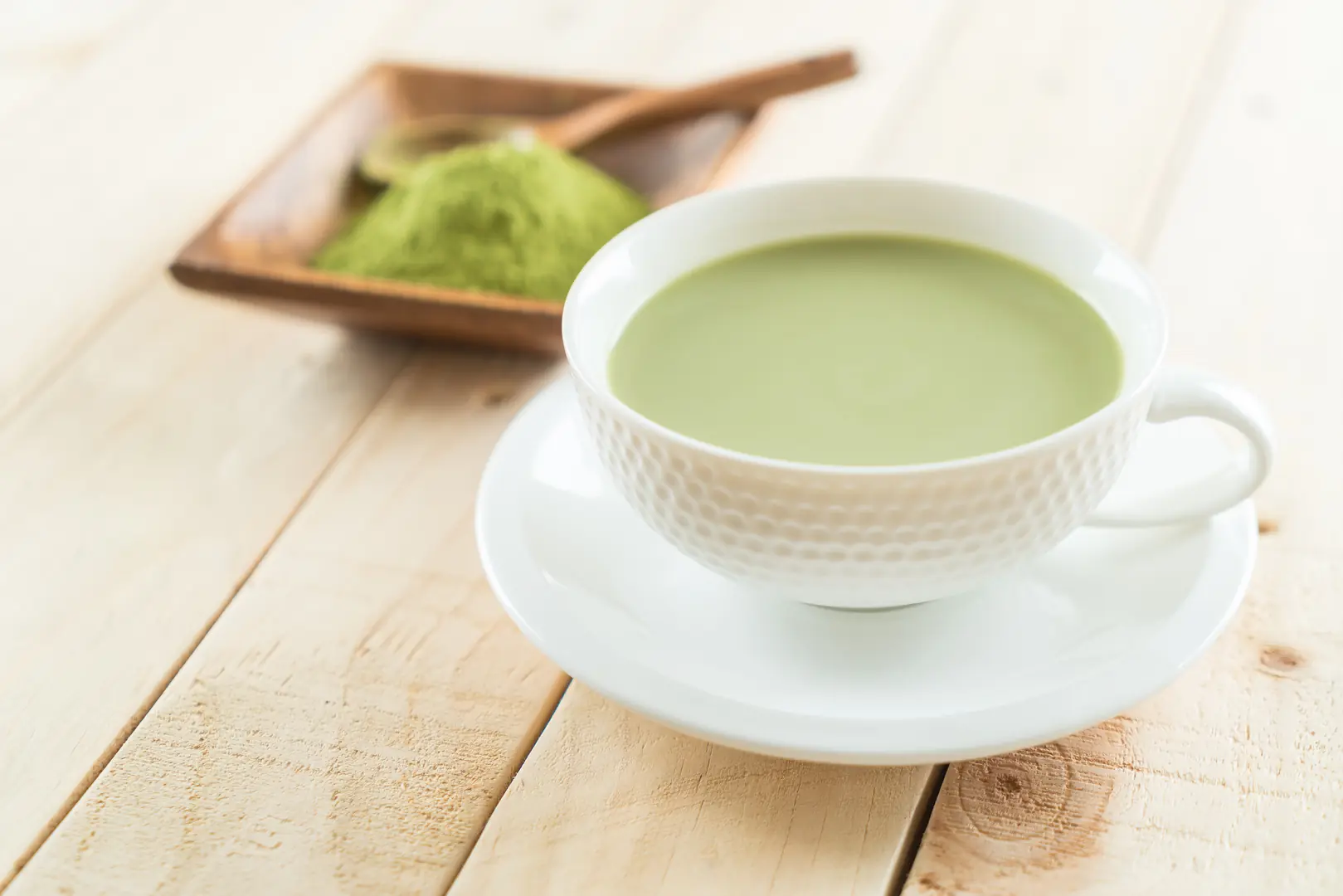 hot matcha latte on wood